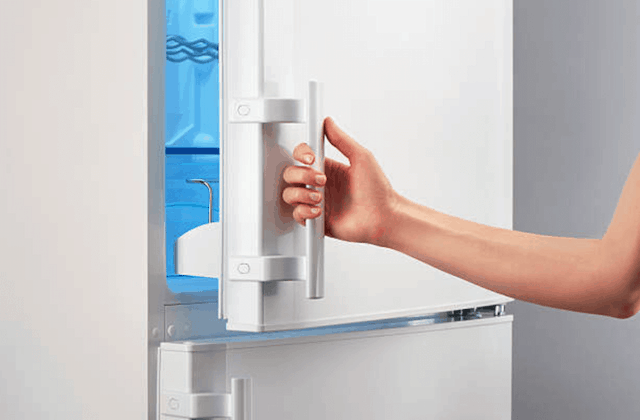 woman opening refrigerator door